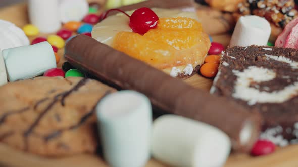 A Sweets and Colorful Candy are Rotating on the Plate alt