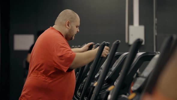 Overweight Man with Strong Determination Is Working in Gym on Is Fat Belly.