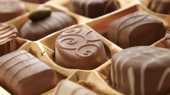 Chocolate from box picking by hand of  many different 4K 2160p 30fps UltraHD footage - Woman chosing alt