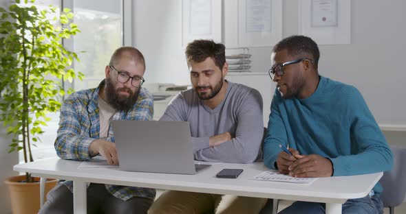 Portrait of Diverse Hipster Men Smiling at Camera Sitting in Modern Office alt