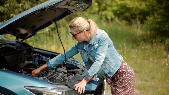 Auto Failure Accident Inspection Oil Level.Frustrated Girl Repairing Damage Car. alt