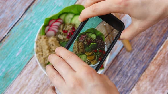 Woman Taking Picture Of Vegan Food Using Smartphone. Healthy Buddha Bowl With Quinoa And Veggies. 