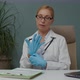 Female Doctor Preparing for Procedure Applying Latex Gloves Indoors - VideoHive Item for Sale