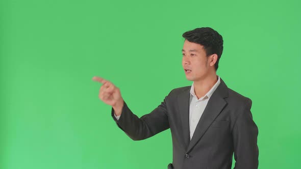 Asian Business Man Threatening With Finger In The Green Screen Studio alt