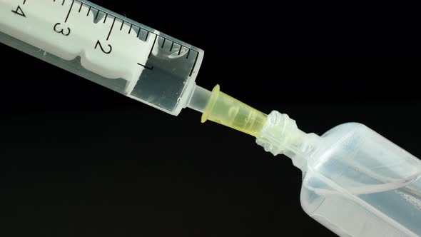 Plastic medical syringe with needle and plastic vial. Medical injection concept.