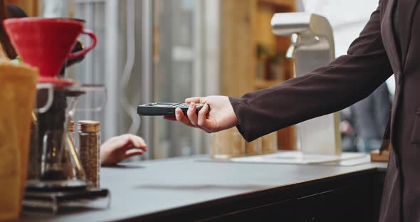 Closeup Woman Paying Using NFC Technology with Phone Contactless Payment with Student Girl Business alt