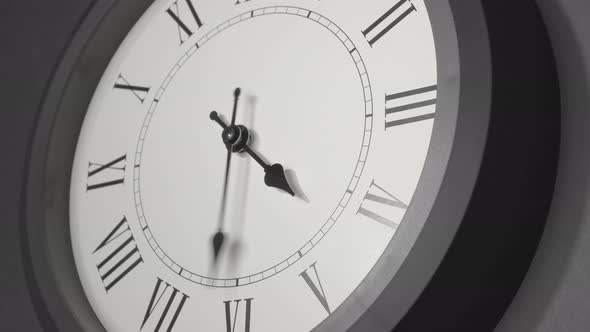 Latin Clock Face In Time Lapse On Dark Grey Wall 
