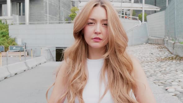 Slow motion young woman dreamy looking camera alt