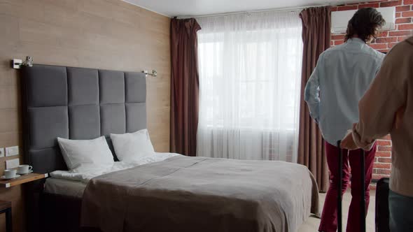 Slow Motion of Woman and Man Going Into Hotel Room and Falling in Bed Laughing alt