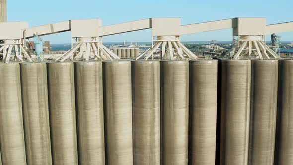 Aerial view rows of tall concrete grain storage silos in Duluth Minnesota - drone tracking day alt