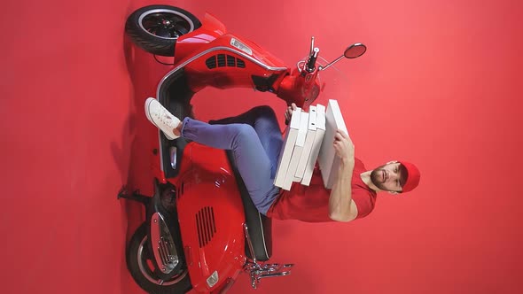 Studio Shooting of a Courier Delivery of Food Pizza To Take Away on a Scooter Chelevek Throws a alt