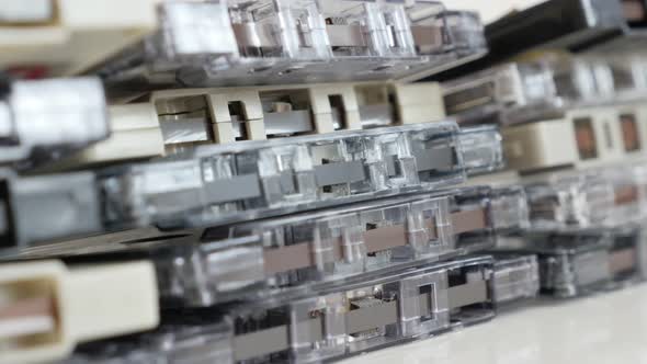 Stacked  analogue  magnetic audio tapes slow tilt 4K 2160p 30fps UltraHD  footage - Music archives o alt