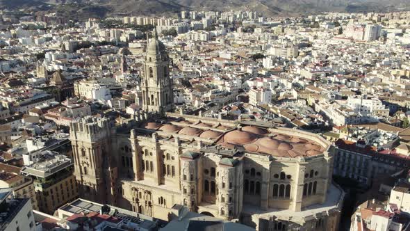 Historic Cathedral on Malaga downtown cityscape, Aerial pullback. Spain