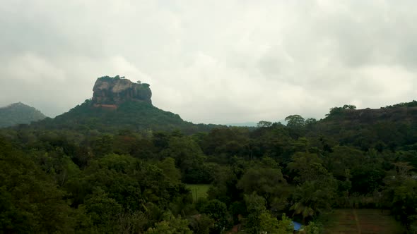 Aerial View of the Holy Mountain Sigiriya, Circling Around the Mountain Through the Clouds