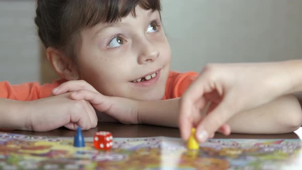 Playful child with board game. alt