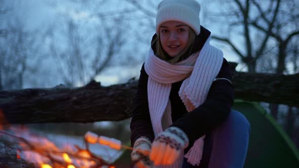Portrait of Happy Caucasian Woman Smiling While Sitting Near Campfire Outdoor and Frying alt