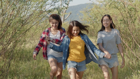 Three young Asian women running having fun together a summer traveling.