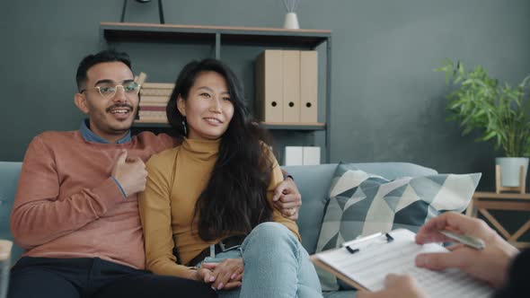 Joyful Young Husband and Wife Talking During Counseling Session with Professional Therapist alt