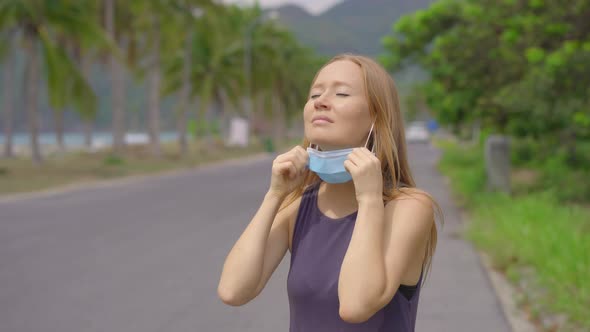 Quarantine Is Over Concept. Woman Taking Off Mask Outdoor. We Are Safe. Coronavirus Ended. We Won alt