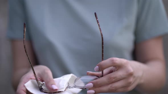 Woman Wiping Glasses with a Napkin alt