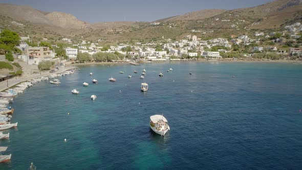 Aerial view of fishing boats anchored on the seashore in Greece. alt