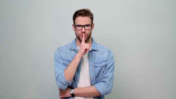 Young caucasian handsome man keeping a secret or asking for silence with serious face alt