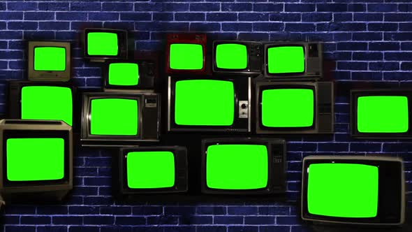 Stack of Retro Vintage TV Turning On Green Screens over Blue Brick Wall. Zoom In. alt