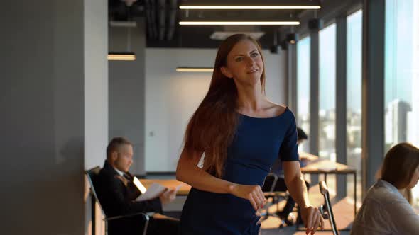 Sexy Businesswoman Happy Dancing Inside of Modern Office alt
