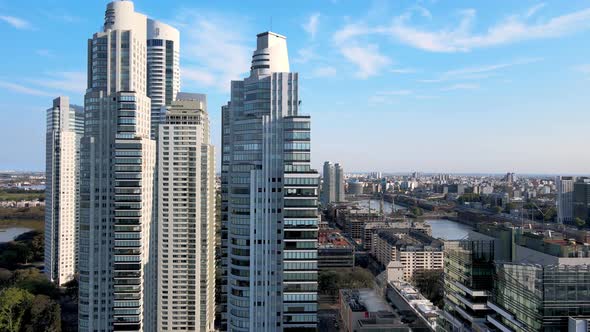 Skyscrapers and river at Puerto Madero, Buenos Aires, backward aerial ...