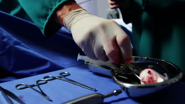 Surgeons performing operation in operation room alt