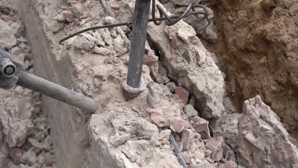 Demolishing an Old Concrete Slab with a Jackhammer alt