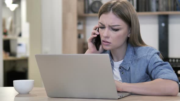 Young Girl Talking on Phone and Discussing Progress alt