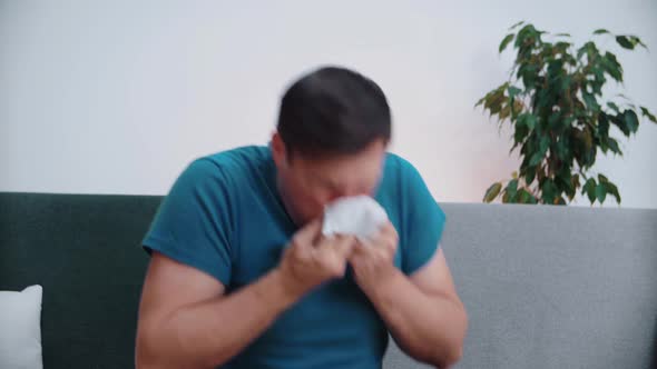 A sick man got an allergy by sneezing into a handkerchief, blowing his nose into a napkin