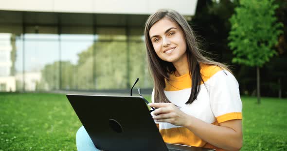 Portrait of Woman with Laptop Working Outdoors