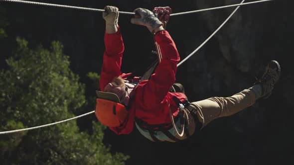 Young Caucasian man zip lining alt