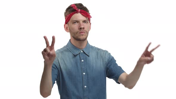 Handsome Bearded Hipster Guy with Red Headband Wearing Casual Shirt Looking Serious and Showing