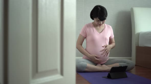 Asian pregnant woman doing video call
