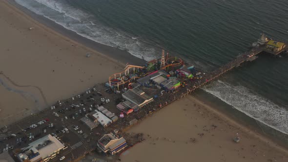 AERIAL: Circling Santa Monica Pier in Sunset Light alt