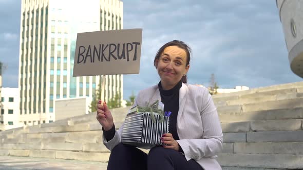Woman Holding Sign with the Inscription Bankrupt alt
