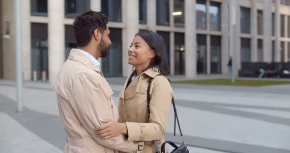 Elegant Diverse Couple Cuddling Outdoors on City Street alt