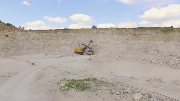 Excavator and dump truck on a construction site alt
