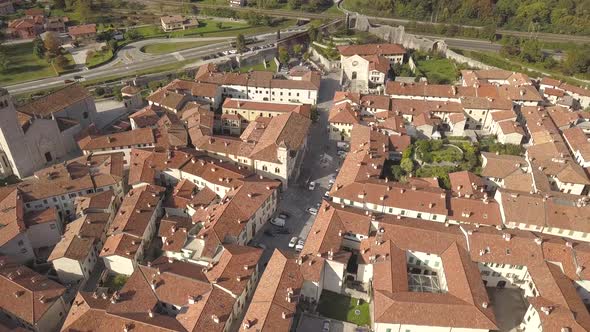 Top Down Aerial View of a Small Historic Town Venzone in Northern Italy with Red Tiled Roofs of Old alt
