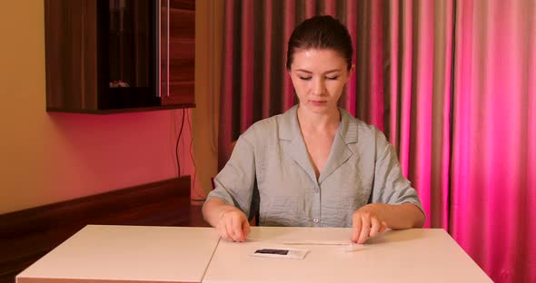 Young woman taking COVID-19 rapid test at home alt