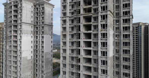 Aerial footage of multistory apartment construction site in China alt