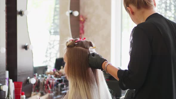 A Hairdresser is Installing the Upgrade of Hair Extension