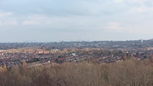 Dolly forward drone shot towards Central London skyline from Alexandra Palace gardens winter alt