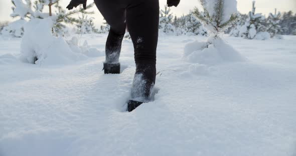 Woman Walking in Deep Snow on Sunny Winter Day Feet and Boots Close Up alt