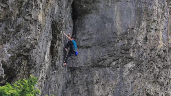 A man rock climbing up a mountain. alt
