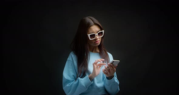 Woman with White Sunglasses is Thinking What to Reply to a Chat Message