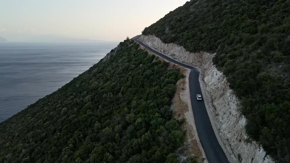 Car Travel Concept Aerial View of Mountain Road Near Sea at Lefkada Island alt